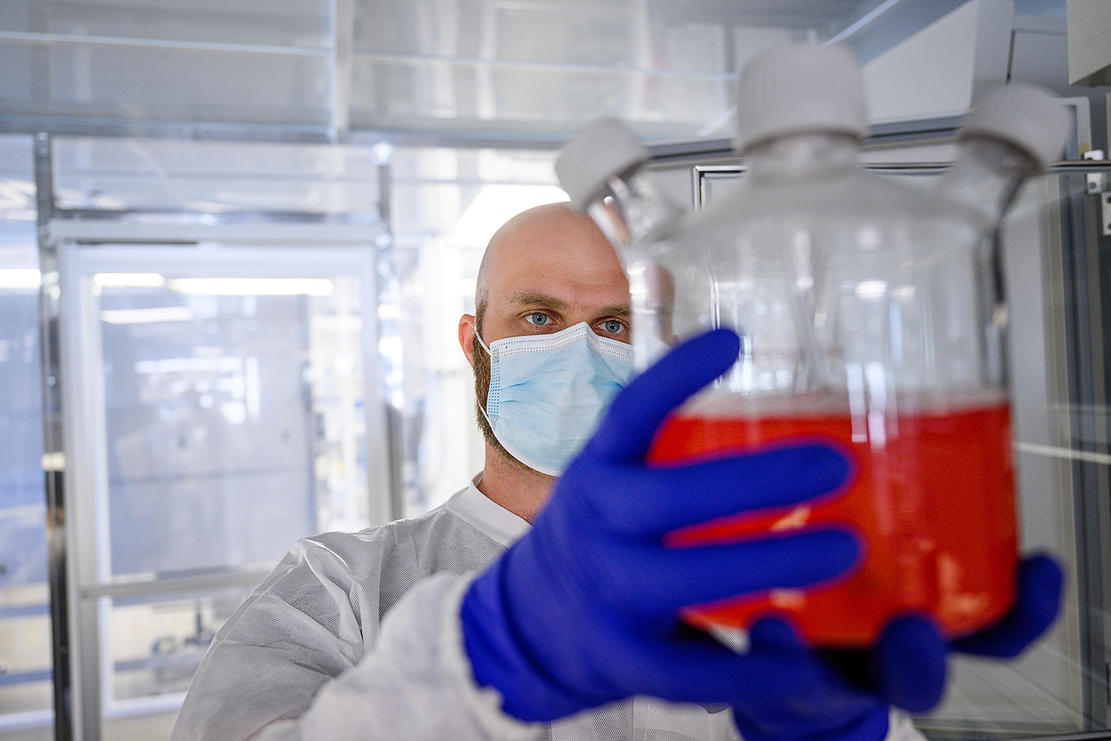 HeartWorks lab technician holding flask of bioengineered cardiac cells.