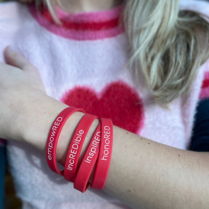 Stack of bracelets for the Coalition for a Cure. Honored, inspired, incredible, empowered.