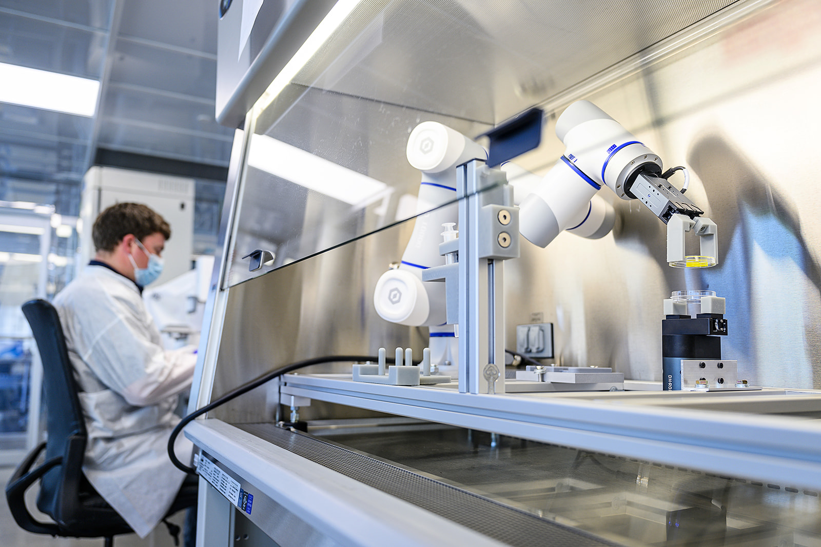 lab technician and 6-axis robot in HeartWorks manufacturing facility