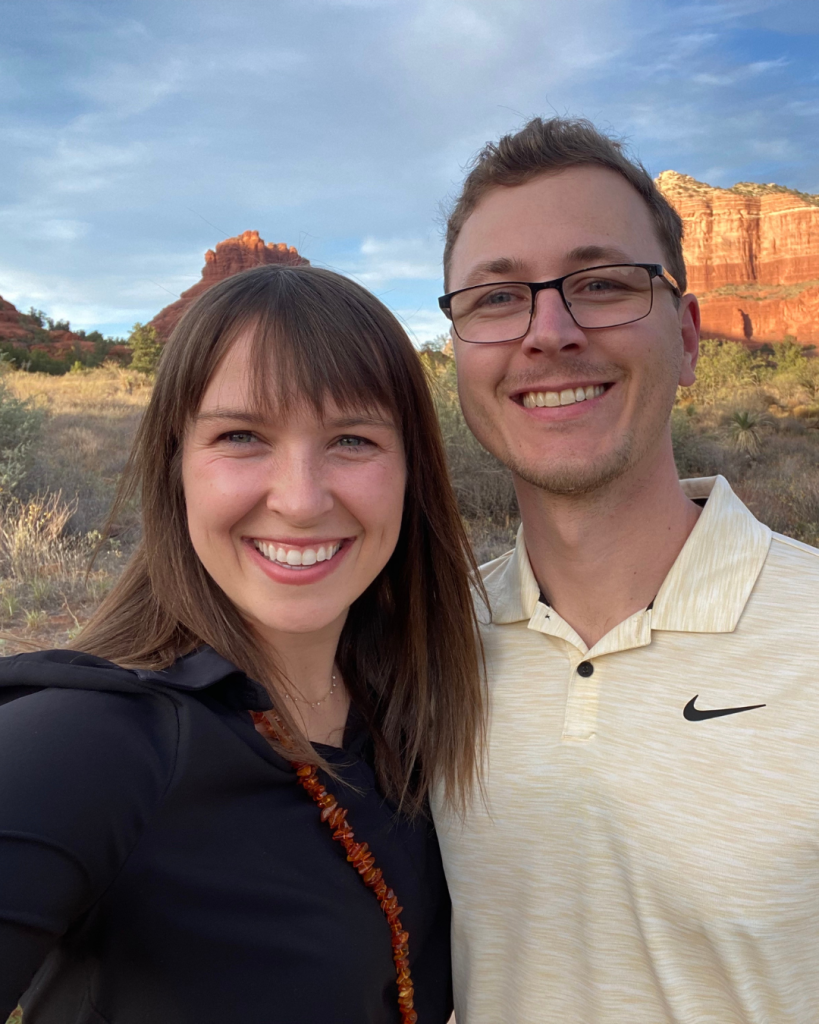 Couple posing in front of nature scene