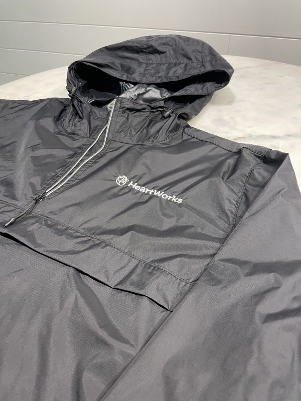 black windbreaker close up with white HeartWorks logo