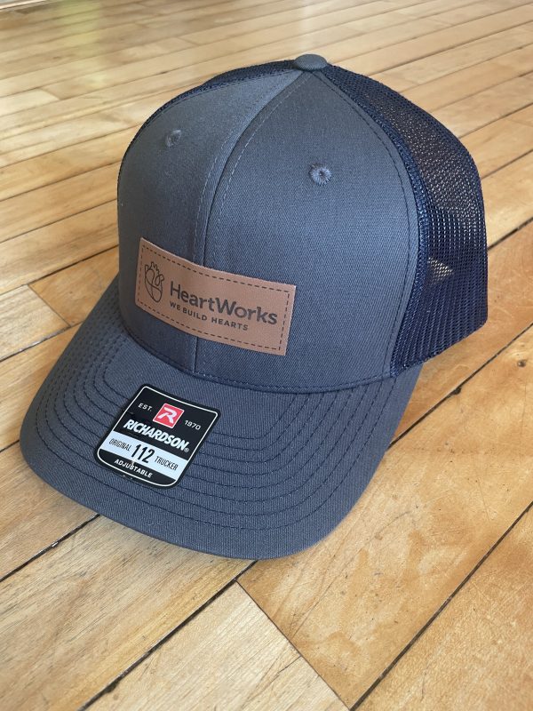 Charcoal and Navy snapback trucker hat with HeartWorks patch
