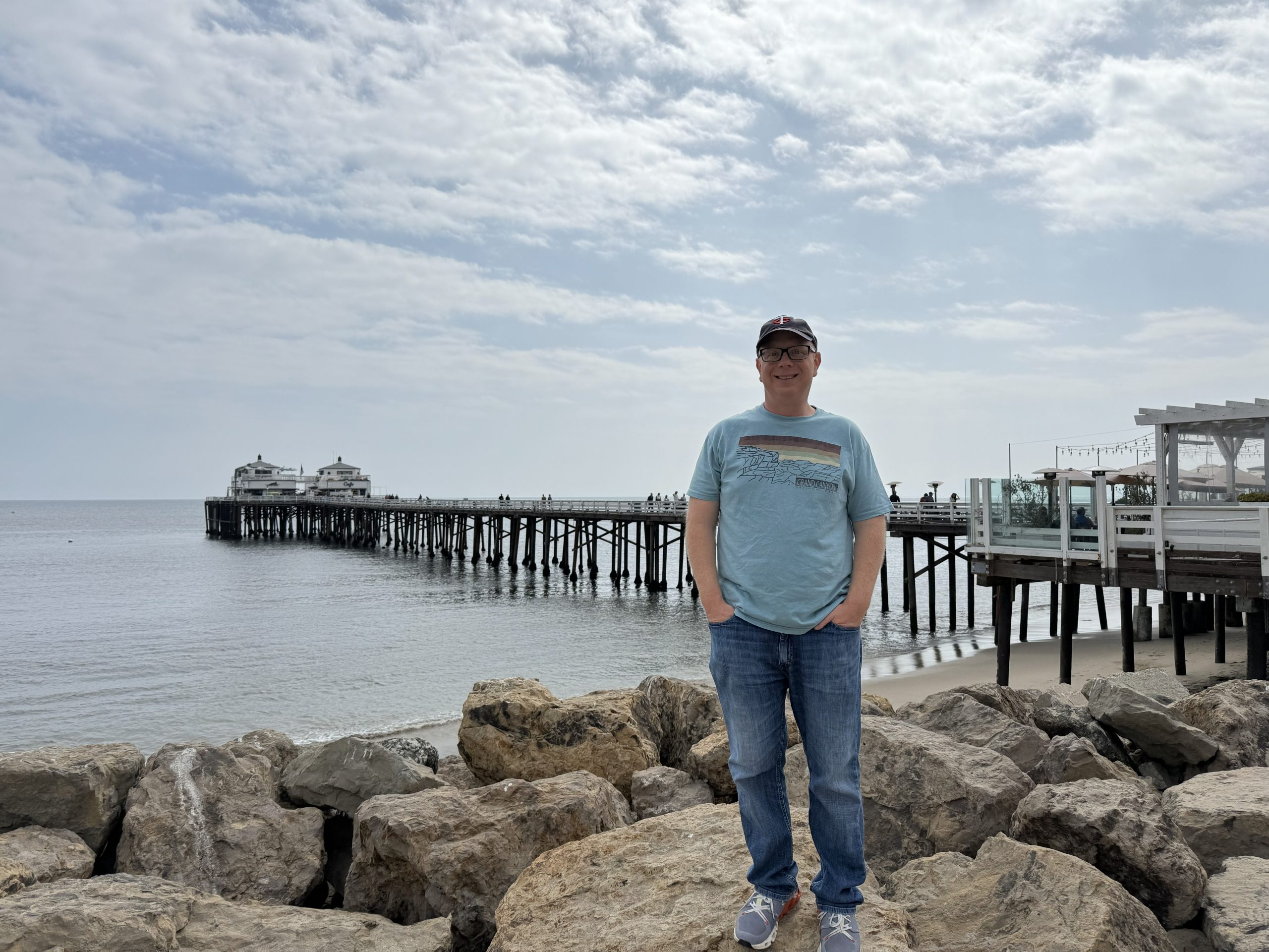 Adam, Director of Clinical Operations, near a pier