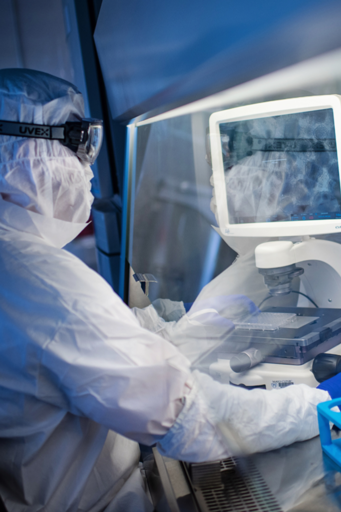 Lab tech looking over iPSCs