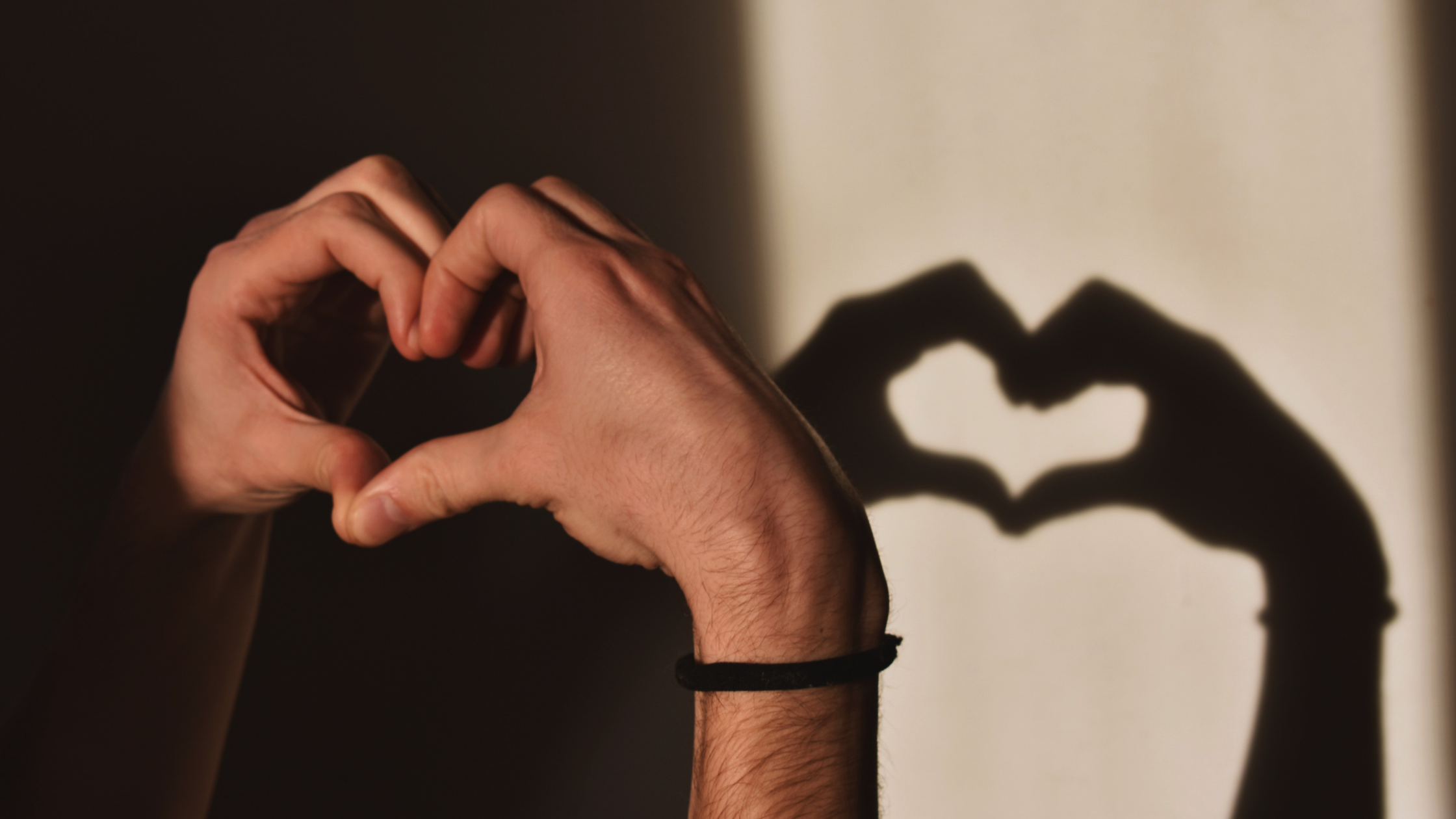 Hands making a heart shape with shadow