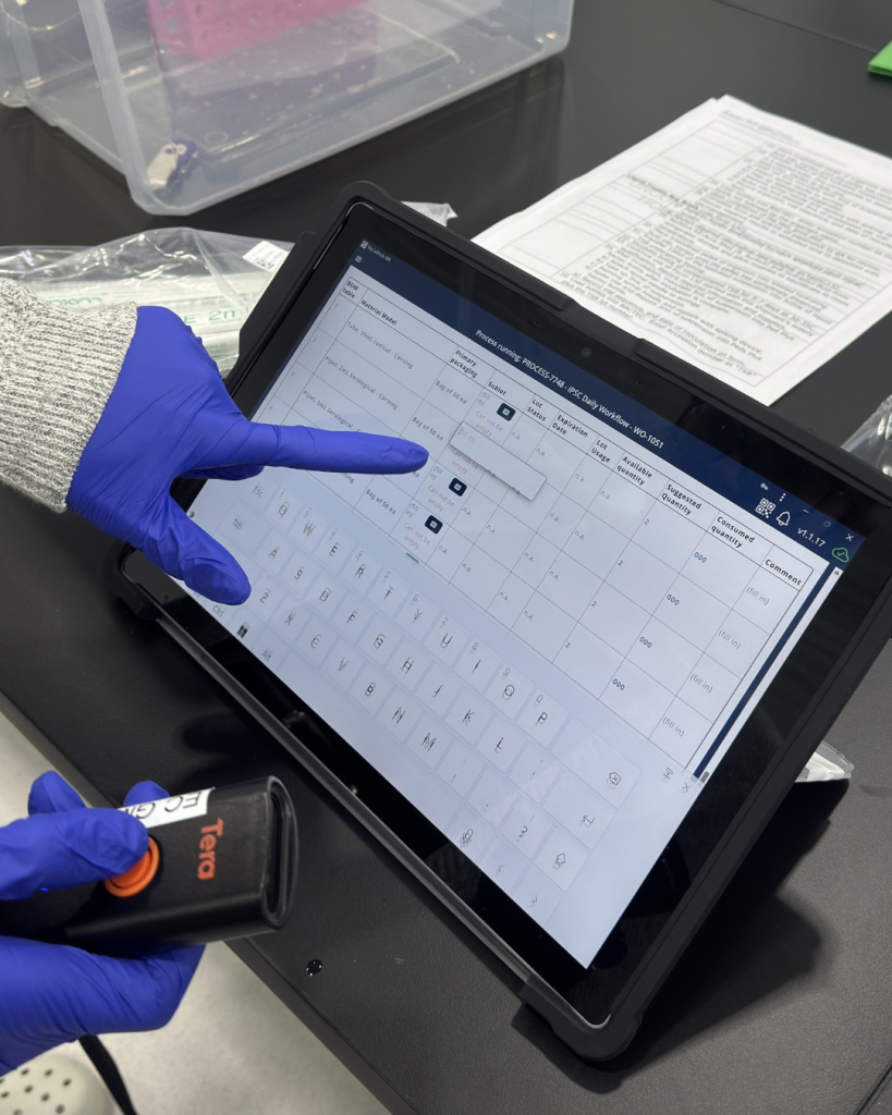 HeartWorks lab team member reviewing electronic manufacturing documentation for congenital heart disease cell therapy production
